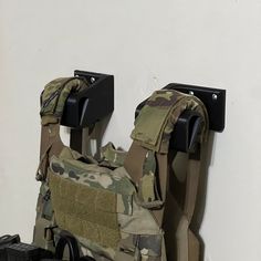 Plate Carrier Wall Mount Securely Holds and Organizes Plate Carrier On The Wall Tested up to 90lbs on only a single hook, Drywall anchors started pulling out  Made in the USA In Stock and Fast And Free Shipping Printed From Durable ABS Plastic Strong One Piece Design Free Returns Includes Drywall Anchor Plate Carrier Holder, Plate Carrier Stand, Hunting Room Design, Gear Stand, Drywall Anchor, Drywall Anchors, One Piece Design, Man Cave Office, Hunting Room