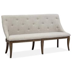 a white couch sitting on top of a wooden frame