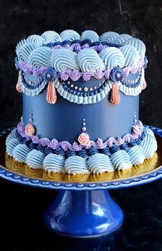 there is a blue cake with purple icing on it