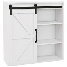 a white cabinet with black handles and sliding doors on the door is open to reveal an empty shelf