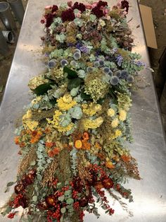 an arrangement of flowers is laid out on a table