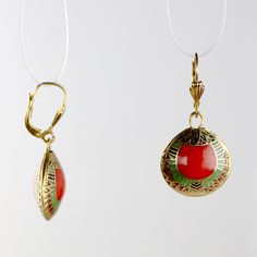 This over 3000 year old design is work of timeless elegance. An exact replica of an ancient Egyptian design from the Egyptian Museum of Cairo, these enamel on copper cloisonné earrings depict abstracted scarabs in a beautifully detailed geometric design. Lever backs ear wires for pierced ears. Size 1 1/2 Inches tall. Traditional Red Oval Earrings, Traditional Oval Red Earrings, Artistic Design Enamel Drop Earrings, Artistic Enamel Drop Earrings, Red Artistic Drop Earrings, Traditional Enamel Drop Earrings, Traditional Drop Earrings With Lever Back, Antique Enamel Earrings For Gift, Traditional Red Enamel Jewelry