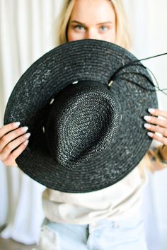 Our Bandera straw hat fits in perfectly with your spring and summer wardrobe, whether at the pool, beach or a concert! On trend w/ a western vibe, classic, chic - everything you've ever wanted in a hat. Featuring a molded crown with a pinched 10cm brim and hand woven straw, it's embellished with a faux leather and silver antique button trim. Finished off with a tassel at the back. -Rancher style hat with a chill & casual vibe-Brim is flexible but holds its shape-Coordinating faux leather band-Pi Black Paper Straw Hats For Summer, Black Paper Straw Hat For Spring, Adjustable Black Straw Hat Made Of Paper Straw, Black Curved Brim Sun Hat For Summer, Black Paper Straw Hat With Curved Brim, Casual Black Paper Straw Hat, Black Paper Straw Summer Hat, Spring Black Paper Straw Sun Hat, Black Panama Hat For Summer