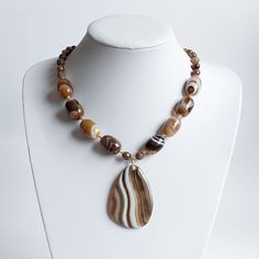 * 20mm large brown banded Agate semi-precious beads * 8mm brown fire Agate semi-precious beads * 10 double sided 14k Gold plated spacers  * 4mm brown Agate beads * Bronze Miyuki spacer beads * 40x60mm large banded agate pendant * The rest of the metals used in this product are 14k Gold Filled (GF 1/20th) * Necklace Length : 20"/51cm What is GOLD FILLED? GOLD FILLED (GF 1/20TH) is a USA industry standard that legally requires 1/20th or 5% pure gold by weight. It's a strictly regulated process tha Brown Carnelian Beaded Jewelry, Brown Agate Gemstone Bead Necklaces, Brown Agate Gemstone Beads Necklace, Brown Agate Gemstone Beaded Necklace, Elegant Brown Agate Beaded Necklaces, Brown Beaded Agate Jewelry, Brown Agate Necklaces With Polished Beads, Brown Agate Beaded Jewelry, Brown Agate Gemstone Necklace