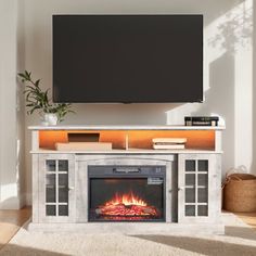 an entertainment center with a fireplace and flat screen tv