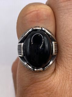 Vintage Onyx Mens Ring 925 Sterling Silver Gothic Genuine Black Onyx  Cool Vintage Rock and Roll star men's ring Nice heavy ring, Sterling silver set with genuine black Onyx with marcasite accents on sides.  Unused stock from the 1970's  I have sizes 10.25 or 12 All jewelry is shipped in a nice gift box.   Check out our over a THOUSAND great reviews We now can custom size to 3-4  or 14-16 etc. Jeweler's fee is $20 to be paid separately.  Takes a week to modify. Engraving is $4 per letter and is not always perfect depending on the piece. It can take a few days if the jeweler is busy. This is payable to Paypal Judithsltd@gmail.com  Engraving is $4 per letter and is not always perfect depending on the piece. It can take a few days if the jeweler is busy. This is payable to Paypal Judithsltd@g Luxury Black Signet Ring Stamped 925, Rock And, Vintage Gothic, Vintage Rock, Mens Ring, Men's Ring, Cool Vintage, Rings Statement, Black Onyx