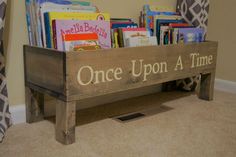 a wooden bench with books on it and the words once upon a time written in white