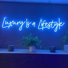 a neon sign that says luxury is a lifestyte on the side of a wall