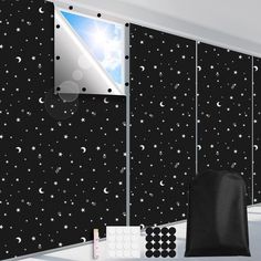 a room with black and white stars and moon wallpaper