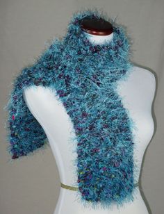 "NOW AND ZHEN * HAND KNIT SCARF IN SHADES OF TURQUOISE* ONE OF A  KIND * FINE WOOL FREE YARNS * THICK * SOFT * WARM *  52\" x 6\" Now and Zhen scarves are plush and substantial.  With a minimum of two strands of yarn used throughout each scarf, the scarves are supple, sensuous and cozy.   They are closely, not loosely knit, as some of the much bigger weave scarves, produced on size 14 and 17 gauge needles -- both for design and cost value.  I use size 11 gauge needles to get a \"tight\" weave. E Knit Plush, Turquoise Scarf, Free Yarn, Faux Fur Scarves, Scarf Yarn, Woven Scarves, Hand Knit Scarf, Cozy Scarf, Shades Of Turquoise