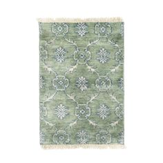 a green rug with blue and white designs on it