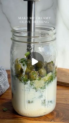 a glass jar filled with food sitting on top of a wooden cutting board