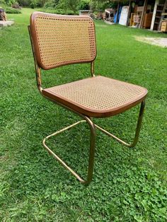 an old folding chair sitting in the grass