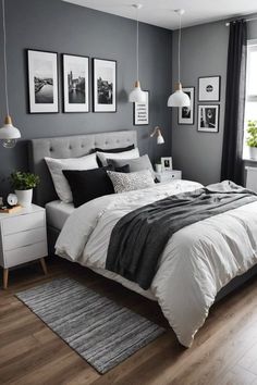 a bedroom with gray walls and white bedding, pictures on the wall above the bed