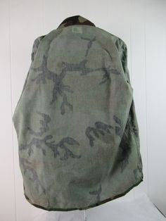 "Vintage 1980s camouflage U.S. Army jacket. Made of green camo poly/cotton. Has a button down front, button cuffs and four pockets. Size XL. Actual measurements are: 55\" at the chest 52\" at the waist 19.5\" shoulder seam to shoulder seam 27.5\" shoulder seam to end of cuff 34\" overall length. In excellent condition." Military Style Green Cotton Windbreaker, Combat Style Camouflage Cotton Outerwear, Combat Cotton Camouflage Outerwear, Camouflage Cotton Combat Outerwear, Winter Camouflage Cotton Utility Jacket, Camouflage Cotton Utility Jacket For Outdoor, Combat Style Cotton Hunting Outerwear, Military Style Camouflage Cotton Outerwear, Green Combat Cotton Outerwear