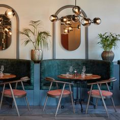 two tables with chairs and mirrors on the wall