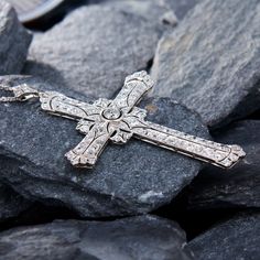 This breathtaking platinum cross shaped pendant features a pierced design with milgrain details and is centered with a round old European cut diamond, weighing 0.28 carats, in a full bezel setting. The center is accented with a total of eighty-eight (88) bead set round cut diamonds. The pendant is topped by a matching bail, bead set with three (3) round single cut diamonds. The pendant measures 71.5mm long, by 46.7mm wide and 4.7mm thick on an 18-inch long, fourteen karat white gold cable link chain, finished with a lobster clasp. Classic Diamond Cross Necklace For Formal Occasions, Diamond Cross Necklace For Wedding, Luxury Cross Necklace For Anniversary, Classic Diamond Cut Cross Pendant Necklace, Classic Diamond Cross Necklace In Diamond White, Classic Diamond White Diamond Cross Necklace, Classic Diamond White Cross Necklace, Elegant Crucifix Diamond Necklace For Anniversary, Classic Diamond Pendant Cross Necklace