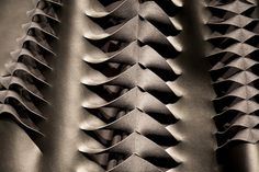 black and white photograph of the back of a leather jacket with wavy lines on it