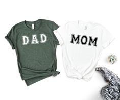 Mom and Dad Shirts, Pregnancy Announcement Shirts, Matching Family Shirt, Mom and Dad Shirts, New Parents Gift, Mom Shirt, Dad Shirt We're here to give you best mother and father shirt options for you. We want to make everyone smile with our cute , stylish and trendy graphic T-shirts. We can assured you this shirt will be perfect Fathers and Mothers Day gift  whether you will buy it yourself or for someone else. Announcement Tee, Baby Shower Tee, Mothers Day Tee, Baby Shower Party Tee BLACK TEXT is used for Yellow, Heather Peach, White, Athletic Heather ,Orange Other colored shirts have white text. MG Design Studio wishes you a pleasant shopping experience.  Please review all listing photos, they are carefully picked to show you the appearance of t-shirt and design. You can find color and White Relaxed Fit Shirt For Family Events, White Relaxed Fit Shirt For Family Occasions, Casual Relaxed Fit Shirt For Family Events, Green Family Matching Shirt With Graphic Print, Green Family Matching Graphic Print Shirt, Green Graphic Print Family Matching Shirt, Casual White Shirt For Family Occasions, Green Short Sleeve Tops For Mother's Day, Casual Mother's Day Shirt For Family Events