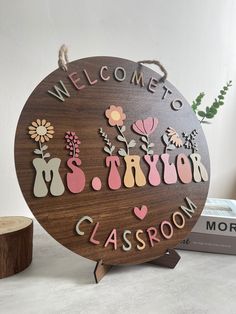 a wooden sign that says welcome to my classroom with flowers and hearts on it