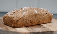 a loaf of bread sitting on top of a wooden cutting board