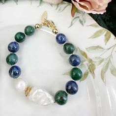 This gorgeous Phoenix Lapis, Baroque Pearl and Freshwater Pearl Bracelet will add the perfect touch of elegance to any outfit. Stylish enough to dress up a formal ensemble, but versatile enough to pair with jeans, this bracelet makes a great gift for any occasion. It will be contained in a nice jewelry box with well packed. Elegant Green Beaded Bracelets For Formal Events, Elegant Green Beaded Bracelets For Formal Occasions, Blue Elegant Beaded Bracelets For Formal Occasions, Elegant Blue Beaded Bracelets For Formal Occasion, Elegant Formal Baroque Pearl Bracelets, Elegant Formal Baroque Pearl Bracelet, Luxury Adjustable Bracelet With Baroque Pearl, Luxury Elegant Baroque Pearl Bracelets, Luxury Baroque Pearl Bracelet