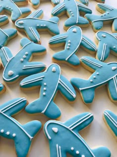 decorated cookies in the shape of airplanes on a table