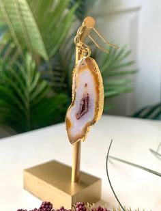 These stylish agate earrings feature a unique contrast between golden orange, milky white, and maroon. The stones are 24k gold edged and will add a striking pop of color to your outfit! 2 1/2'' Long 14k Gold-filled Earring Hooks Handmade Gold Agate Earrings, Gold Agate Gemstone Earrings, Gold Agate Earrings With Natural Stones, Gold Earrings With Natural Agate Stones, Gold Agate Drop Earrings, Gold Agate Earrings, Orange Agate, Agate Earrings, Milky White