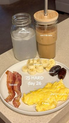 a breakfast plate with eggs, bacon, and coffee on it next to a jar of milk