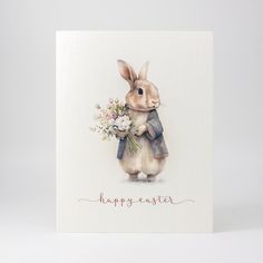 a greeting card with a watercolor painting of a rabbit holding a bouquet of flowers