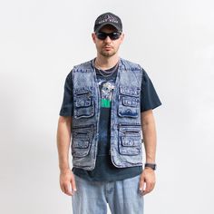 Vintage 90's cargo style denim vest in stonewashed blue - with a front zip - features four main pockets and several smaller ones - materials: denim SIZE from the tag: L MEASUREMENTS chest: 44 inches (112 cm) length: 29 inches (73 cm) The model is 6'1" (186 cm), measures 41-35-39 (104-88-100 cm) and typically wears clothing in size L CONDITION: 9/10 - The vest in great vintage condition. Washed, ready to wear. Casual Washed Blue Denim Vest With Pockets, Urban Style Denim Vest With Pockets For Spring, Casual Denim Blue Vest For Streetwear, Washed Denim Jacket For Outdoor, Summer Utility Style Sleeveless Denim Vest, Utility Vest With Pockets For Streetwear, Utility Denim Vest With Pockets, Utility Cotton Denim Vest For Summer, Summer Utility Cotton Denim Vest