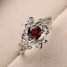 This ring features a (6*6 mm round cut natural garnet). Customization is available. It is made by hand, and it will take about 7 days to finish the ring after your payment is completed. Main stone: 6*6mm round cut natural garnet Main stone weight: 1.21 ct Metal type: sterling silver finished with rhodium/14k gold Accent stone: None Customization is available, I also can make it with 14k solid gold (white or yellow or rose) and diamond accent stone, just feel free to contact me. Any question, jus Garnet Silver Ring, Unique Silver Engagement Rings, Unique Garnet Ring, Garnet Wedding Rings, January Birthstone Rings, Couples Ring Set, Fancy Rings, Magical Jewelry, Gothic Rings