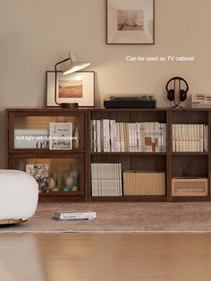 a living room with bookshelves and pictures on the wall