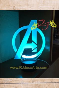 the avengers logo is lit up with blue light