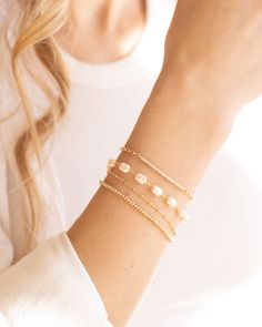 Elevate your outfit with the Lily Bracelet. This chunky pearl bracelet is a must-have addition to any fun and chic outfit. With an extender for easy wearing, it is one of our favorites. Stacked here with our Chloe Bracelet, Camilla Bracelet, and our Devon Bracelet. The sister to this is our Lily Necklace! Details: - Gold Filled - 2" extender Party Pearl Drop Beaded Bracelets, Chic Adjustable Pearl Bracelet With Pearl Charm, Chic Adjustable Pearl Bracelet With Charm, Chic Adjustable Pearl Bracelet, Elegant Pearl Bracelet With Extender, Trendy Pearl Bracelets With Pearl Charm, Trendy Pearl Charm Bracelets, Chic Adjustable Bracelet With Pearl Charm, Chic Pearl Charm Bracelet As Gift