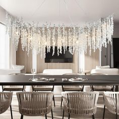 an elegant dining room with chandelier hanging from the ceiling and chairs around it