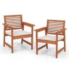 two wooden chairs sitting next to each other