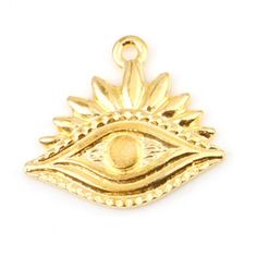 a gold pendant with an eye on it