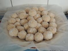 a bunch of food sitting on top of a table next to a bowl filled with powdered sugar