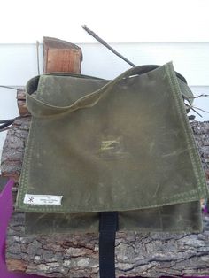 "This is a traditional haversack make with waxed OD green canvas. It's aprox. 12\"X12\" with a 60\" strap. This bag is great for around town trips as well as a multi-day trip into the bush. The canvas has been permeated with wax at the fabric mill so it is completely infused. This ensures that the bag will be water resistant and rugged enough for any adventure for years to come. comes with a 1\" fastex style closure to ensure the flap stays closed and tight. Waxed canvas has a long lifespan beha Military Style Durable Bag For Everyday Use, Durable Military Style Bag For Everyday Use, Functional Waxed Canvas Hiking Bag, Outdoor Waxed Canvas Bag, Green Crossbody Satchel For Outdoor, Green Waxed Canvas Bags With Adjustable Strap, Durable Everyday Waxed Canvas Bag, Everyday Durable Waxed Canvas Bag, Rectangular Waxed Canvas Satchel For School