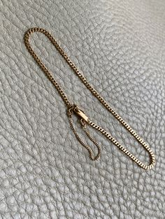 A great budget friendly silky pressed curb link bracelet! Made in 1942 from solid 18k gold, this vintage piece measures 7.5" long and has the silkiest movement. Box clasp is well working with both a safety loop and safety chain. Hallmarked for year, gold purity and the triple crown for Sweden.Excellent vintage condition with normal age related wear. Details Made in 1942 7.5 inch length 2mm width 2.7 grams 18k gold (solid, not plated or fill) Marked for maker, year, gold purity, and the triple cr Vintage Gold Necklace, Triple Crown, Safety Chain, Box Clasp, Leather Jewelry, Bracelet Sizes, Ring Bracelet, Link Bracelets, Vintage Gold