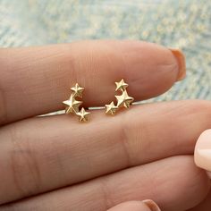 See more Earrings! https://www.etsy.com/uk/shop/LilyCharmed?ref=seller-platform-mcnav&section_id=17718702 These star cluster stud earrings are the perfect earring accessory for everyday wear! A stunning celestial ear climber crafted from sterling silver or 18ct gold plated silver. Each earring features three dainty stars that have been faceted with a smooth finish to catch the light and give a delicate shimmer. This earring has been inspired by the cosmos for an understated glamourous access Elegant Star Embellished Earrings As Gift, Elegant Star Embellished Earrings For Gift, Tiny Star-shaped Earrings For A Gift, Tiny Star-shaped Earrings As A Gift, Tiny Star-shaped Earrings For Gifts, Gold Star Earrings As Gift, Gold Star Earrings For Gift, Gold Star Jewelry For Christmas, Dainty Stars