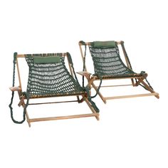 two lawn chairs sitting next to each other on top of a wooden frame with rope