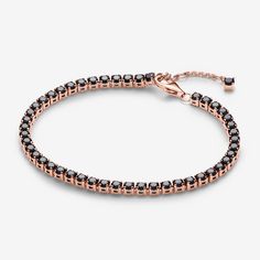 Add boldness to your look with the Black Sparkling Tennis Bracelet. Plated with 14k rose gold, it showcases 48 prong-set black man-made crystals in squared open baskets. The adjustable closure with a dangling stone offers a personalized fit. Ideal for stacking with various colours and metals, this bracelet introduces a bold black stone to Pandora's Timeless collection. Experience the elegance of repetition and contrast, adding depth to your bracelet stack. - Pandora Black Sparkling Tennis Bracelet - 14k Rose gold-plated unique metal blend / Man-made crystal / Black - Sz. 7.9 in Pandora Black, Black Man, Bold Black, Black Stone, Lab Created Diamonds, Tennis Bracelet, Bracelet Stack, Bracelet Sizes, Rose Gold Plates