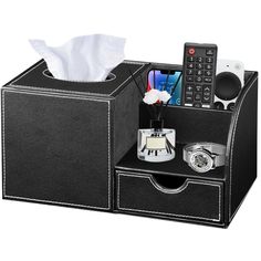 a tissue dispenser with a cell phone in it and other items inside