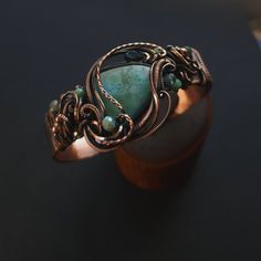 Handcrafted copper cuff bracelet caribbean larimar gemstone, smooth, unique shape, genuine gemstone  london blue topaz teardrop accent  glass & copper accent beads  1/2" wide hand formed copper cuff band, adjustable fit  pure copper wire wrapped, oxidized for an antiqued finish, tumlbed and polished  unique wearable art {ocean inspired} 🌊 comes nicely packaged with a business card, jewelry care instructions and a polishing cloth Adjustable Bronze Gemstone Jewelry, Adjustable Turquoise Nature-inspired Jewelry, Cabochon Bangle As A Gift, Cabochon Bangle Jewelry Gift, Elegant Hand Forged Bangle As Gift, Handmade Adjustable Aquamarine Bracelet, Handmade Aquamarine Round Jewelry, Aquamarine Bracelet Jewelry Gift, Aquamarine Bracelet Jewelry As A Gift