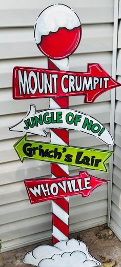 a street sign with multiple signs on it in front of a building that says mount crumpit, jungle of no grin's lab whoville