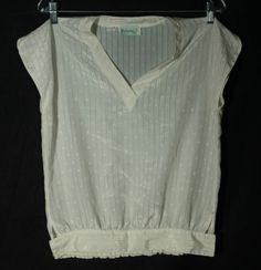 "Here's a sweet and special collectible 1970's boho white super lightweight 1970's \"Bethany\" label top! This 70s top has a silky synthetic texturized striped material that's precious. The construction and tailoring is sweet too: It has a v neckline, a side button waist with elastic ruching in the back.  This vintage top is in great condition with normal signs of wear/use and no major damage. The label says this blouse is a vintage size 7/8 and flat measurements are here for you to check the fi Vintage Cotton V-neck Blouse, Vintage V-neck Festival Top, Vintage V-neck Top For Festival, Vintage White Blouse For Summer, Vintage White Summer Blouse, Vintage V-neck Cotton Blouse, Vintage Cotton Blouse For Festival, Vintage Fitted Blouse For Festival, Vintage White V-neck Blouse