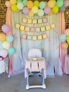 a baby's first birthday party with balloons and decorations