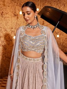 Dive into the charm of this aqua lehenga set featuring a crush shimmer fabric skirt. The skirt is adorned with embroidered detailing on one side of the border, creating a captivating look. The fully embroidered blouse adds a touch of opulence to the ensemble. Designed for comfort, the outfit is padded and features a hook-eye closure on the back. Embrace elegance and grace with this meticulously crafted aqua lehenga set, perfect for making a statement at any special event. Sequin Chinon Dress For Reception, Festive Party Wear Saree Sets, Party Wear Sharara With Traditional Drape In Chinon, Party Wear Anarkali Set With Sequins, Festive Party Wear Sharara With Unstitched Blouse, Party Wear Choli With Unstitched Blouse In Traditional Drape, Unstitched Blouse Choli For Party Wear, Party Wear Choli With Unstitched Blouse, Festive Anarkali Set With Unstitched Blouse